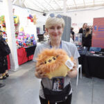Cool merch - participant happily holding a new plush Pusheen